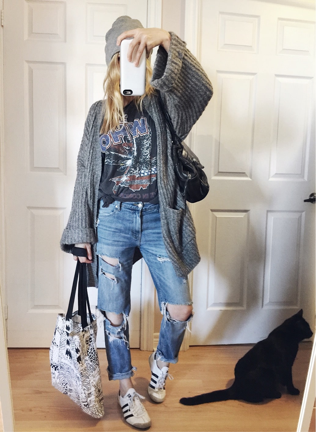 Oversized cardigan, band tee, boyfriend jeans, beanie, and Adidas