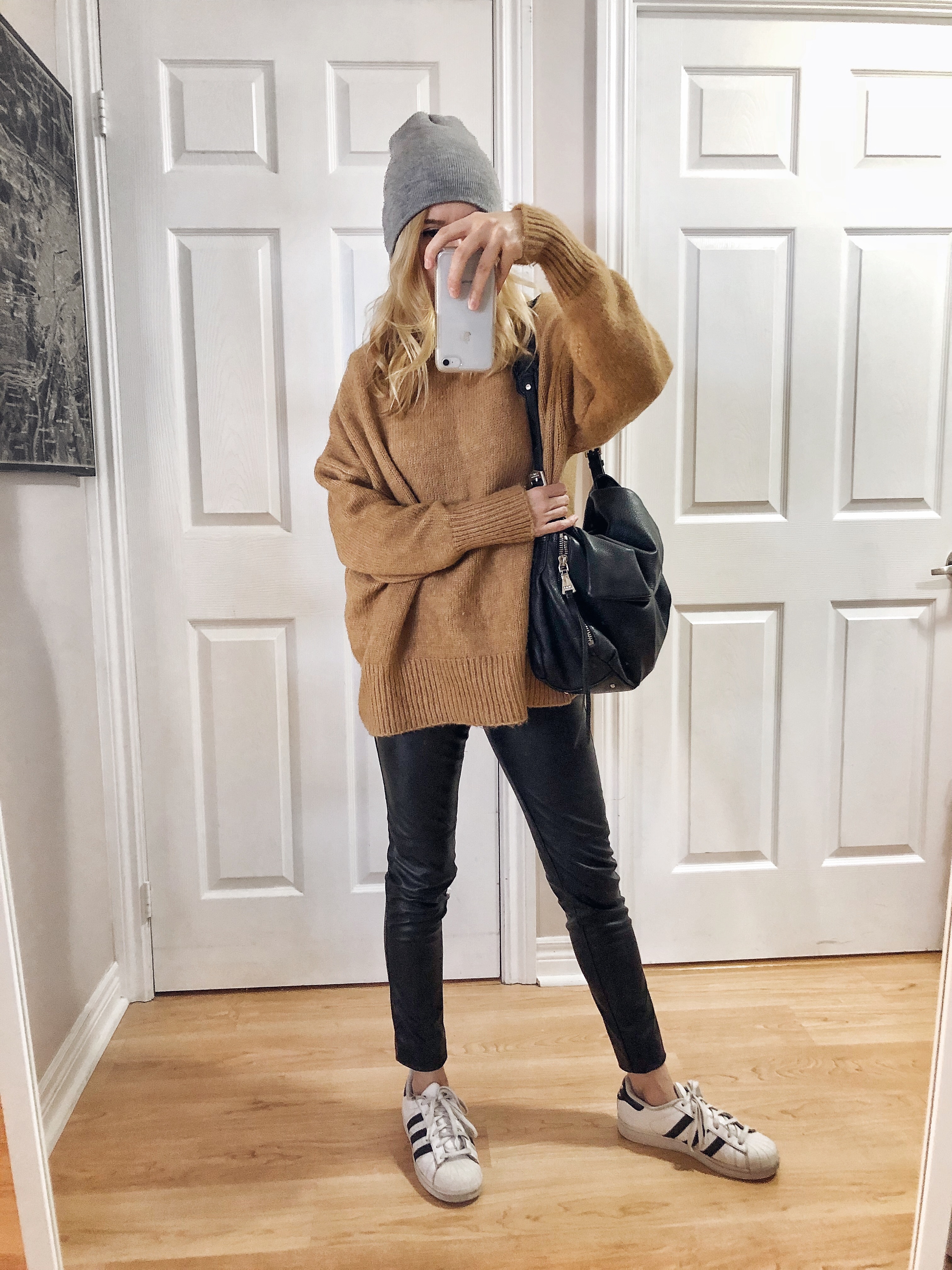 What I wore. I am wearing an oversized sweater, faux leather leggings, and Adidas