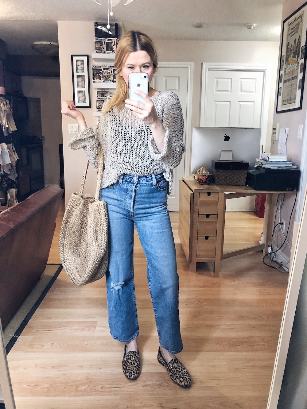 What I Wore This Week. I am Wearing an open knit seater, black camisole, Levi's Ribcage jeans, Sam Edelman Loafers, and a large circular woven bag. #livelovesara