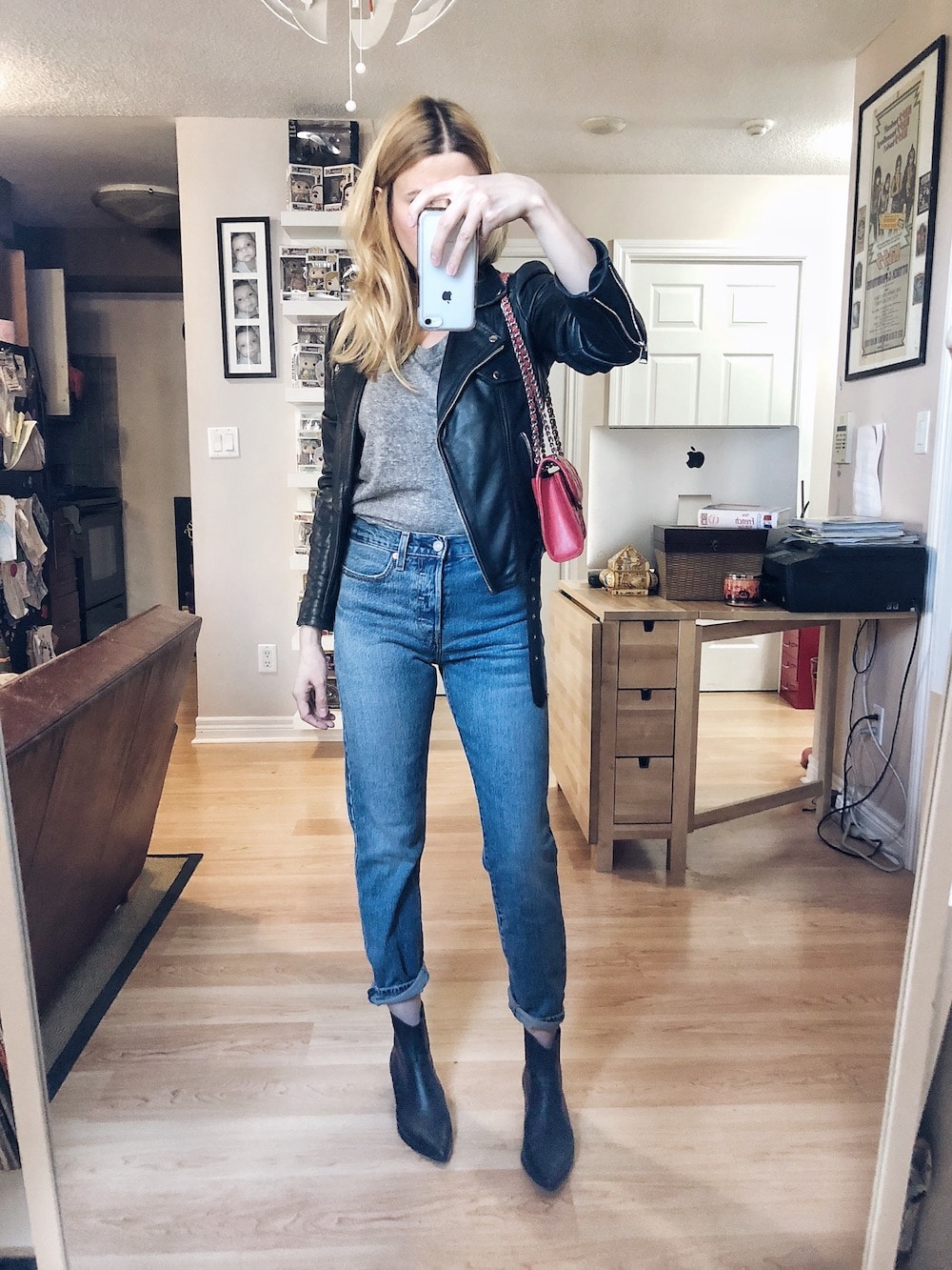 What I wore this week. I am wearing the Madewell ex-boyfriend tee, Levi's Wedgie Icons, a black leather jacket, black booties, and a red Rebecca Minkoff purse. #livelovesara