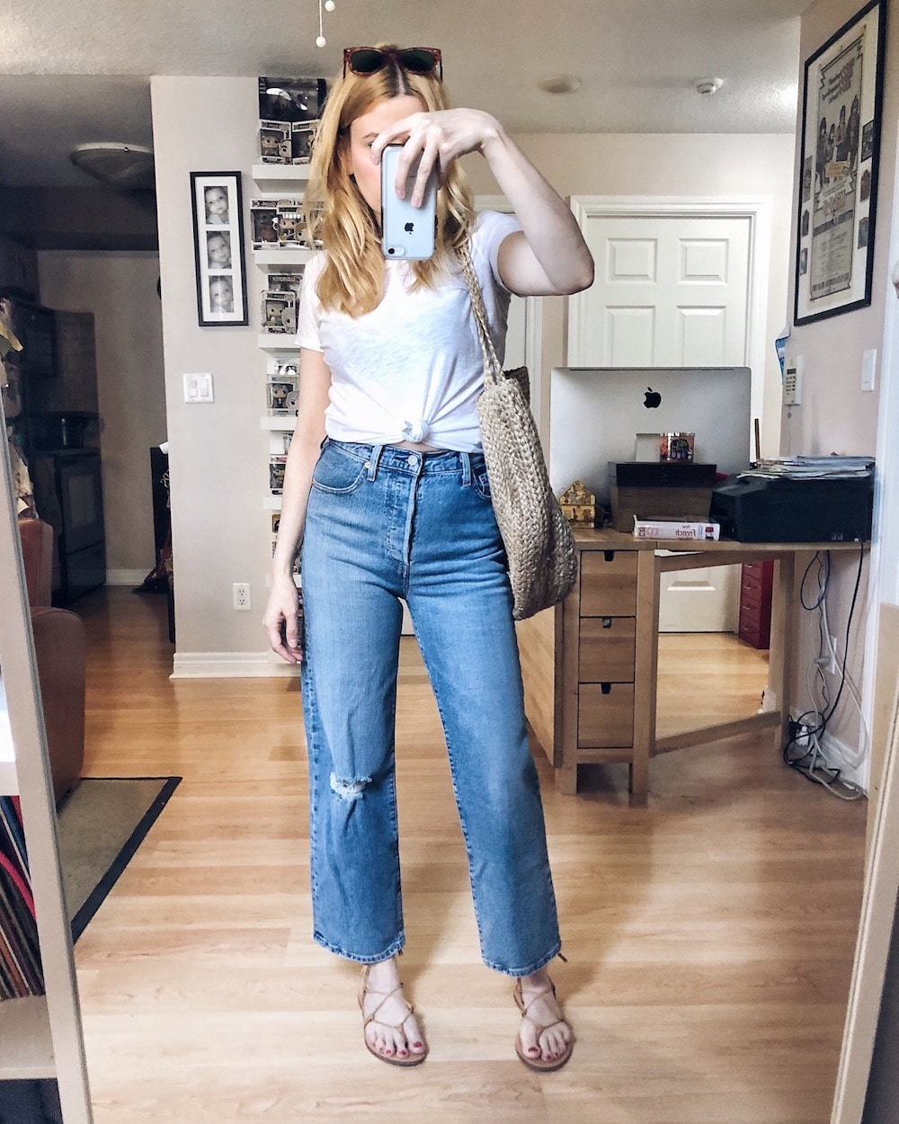 What I wore this week. I am wearing a knotted white tee, blue Levi's Ribcage, Madewell Boardwalk sandals, vintage Ray-Bans, and a large woven bag. #springstyle #summerstyle #livelovesara What I wore this week. I am wearing a knotted white tee, blue Levi's Ribcage, Madewell Boardwalk sandals, vintage Ray-Bans, and a large woven bag.