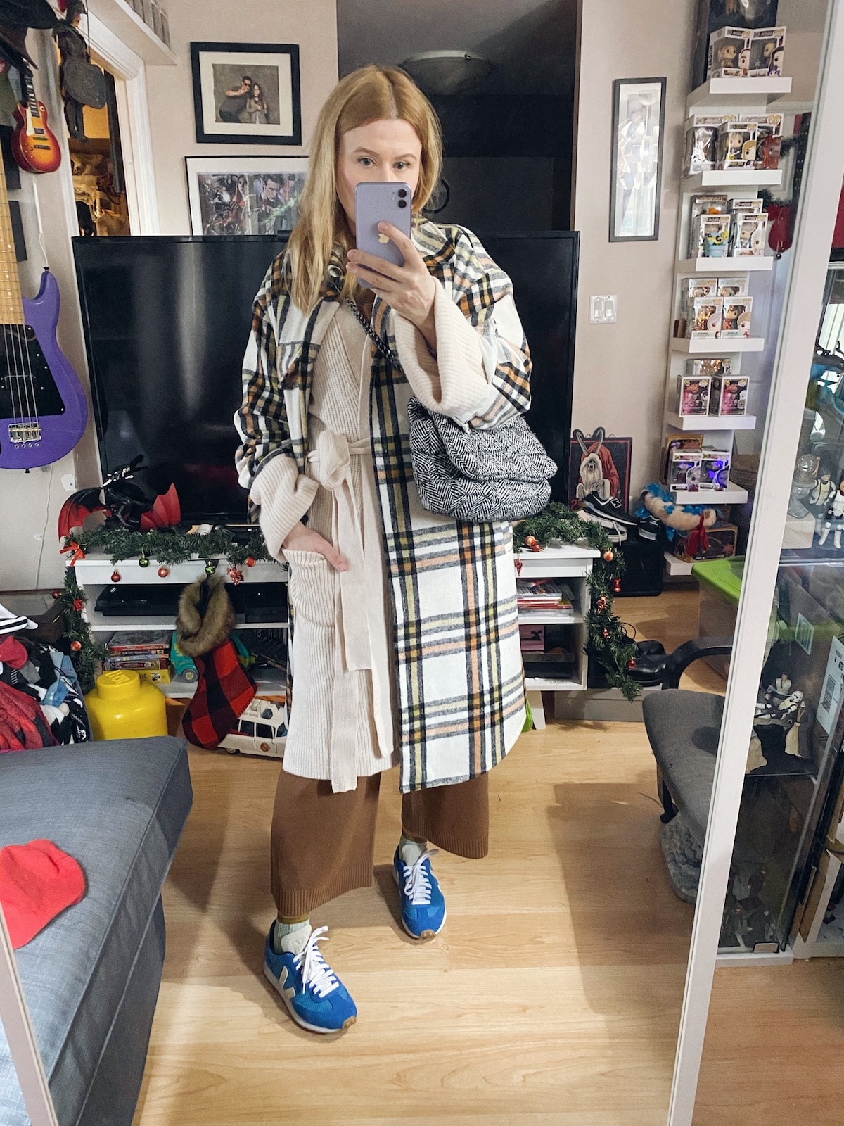 I am wearing a cashmere jumpsuit, oversized cardigan, and a shacket, with Vejas and a Zara bag.