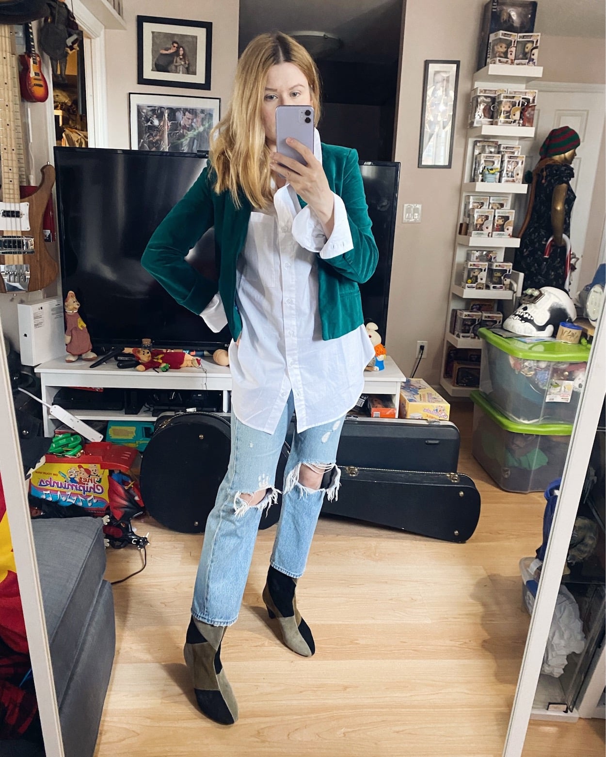I am wearing a white oversized button down, Levis, Isabel Marant Patch boots, and a cropped bottle green blazer