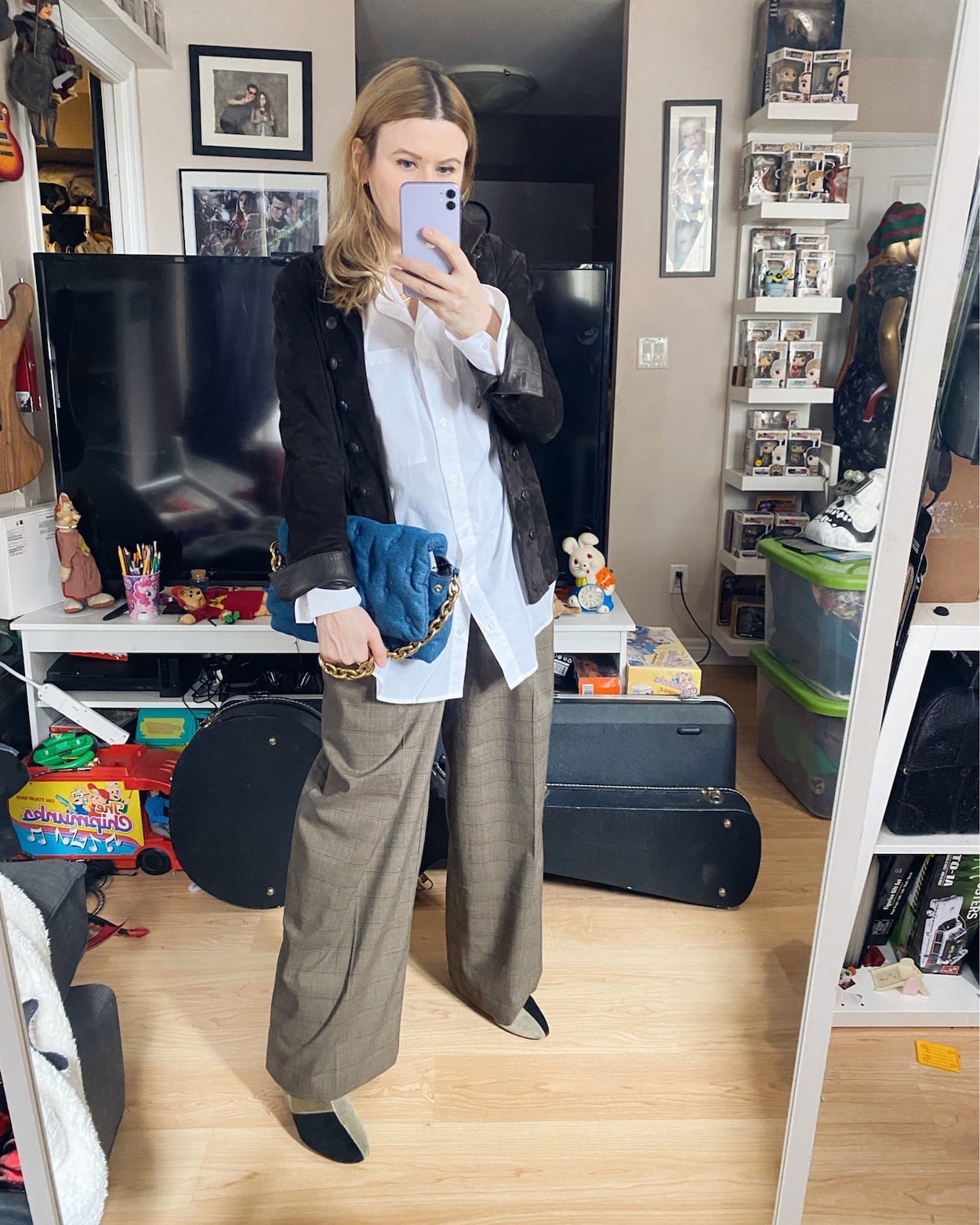 I am wearing a white oversized button up, wide leg trousers, Isable Marant Patch boots, and a vintage suede band style jacket.