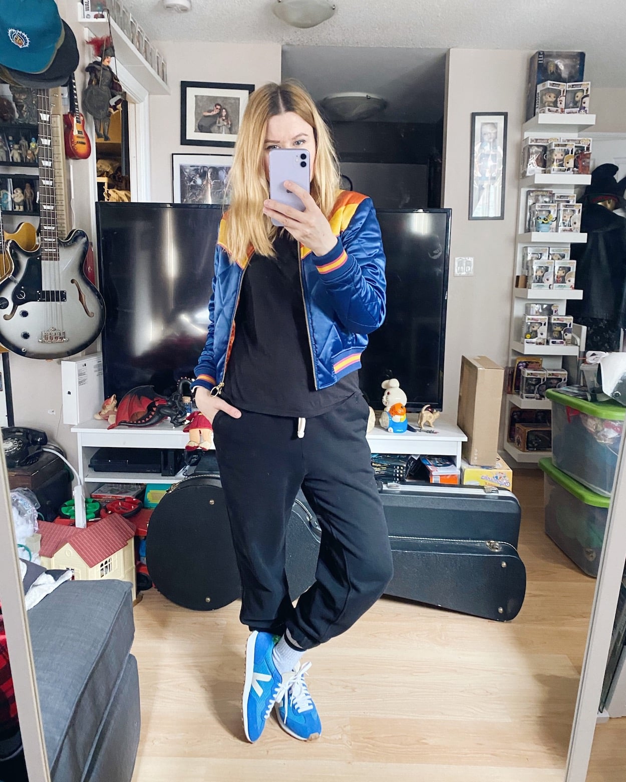 I am wearing a black t-shirt, black joggers, a retro bomber, and vejas