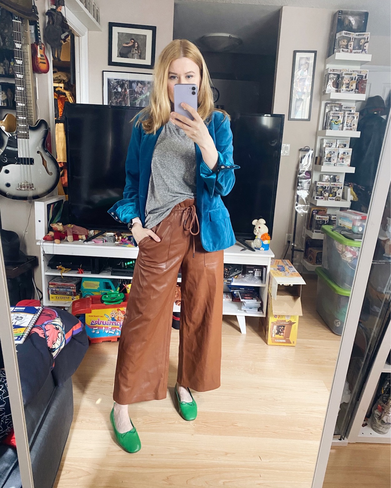 I am wearing a grey t-shirt, brown wide leg faux leather trousers, a blue velvet blazer, and green flats