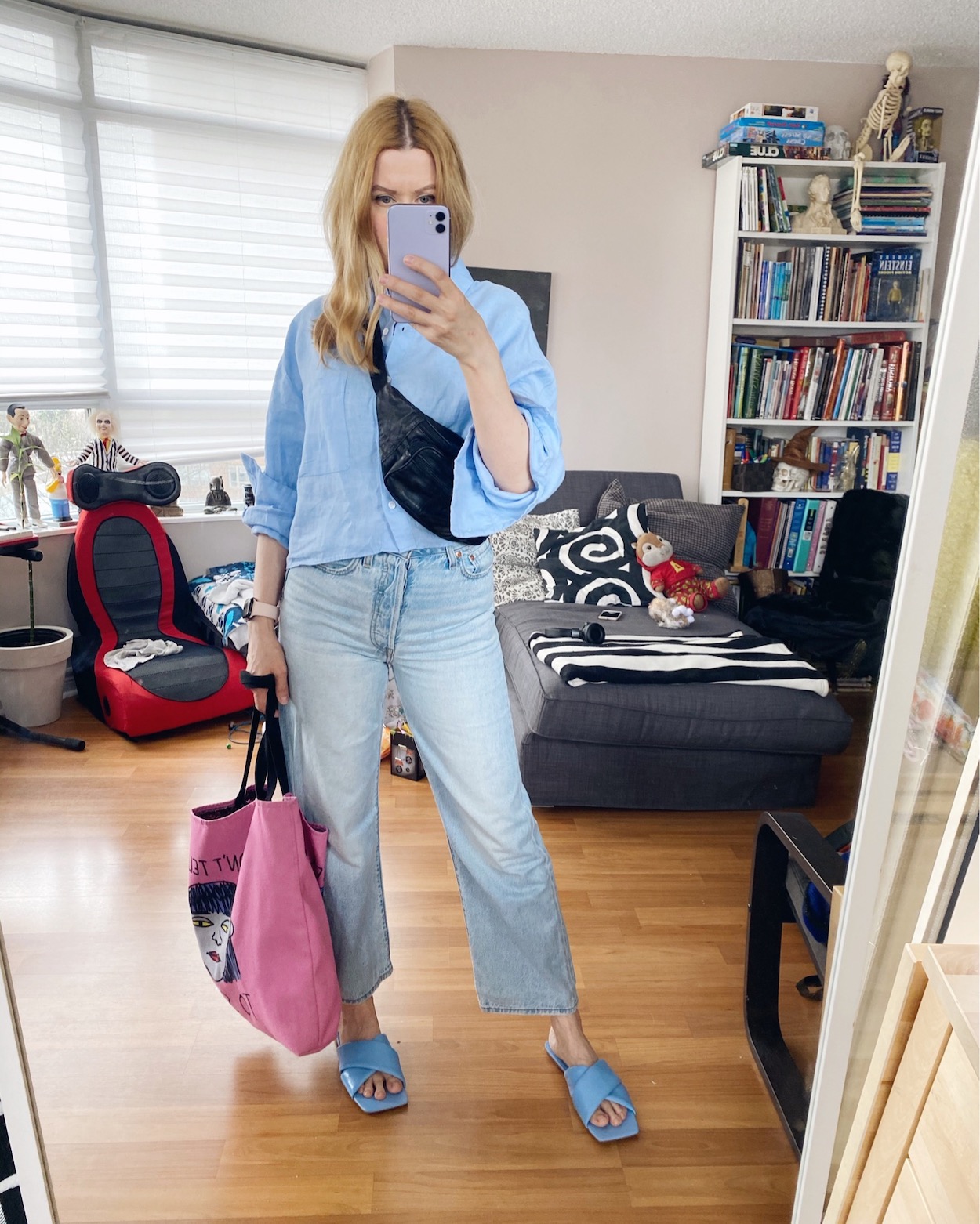 I am wearing a blue linen cropped blouse, Levis, and blue puffy sandals.
