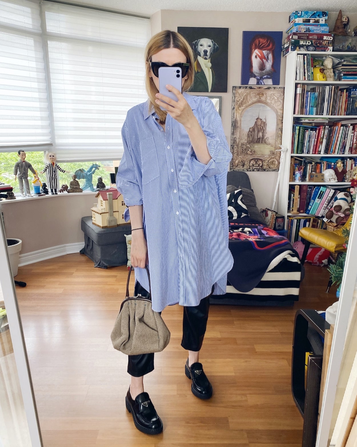 I am wearing an oversized button up, leather trousers, Prada Loafers, Vintage Miu Miu bag, and Le Specs Sunglasses.