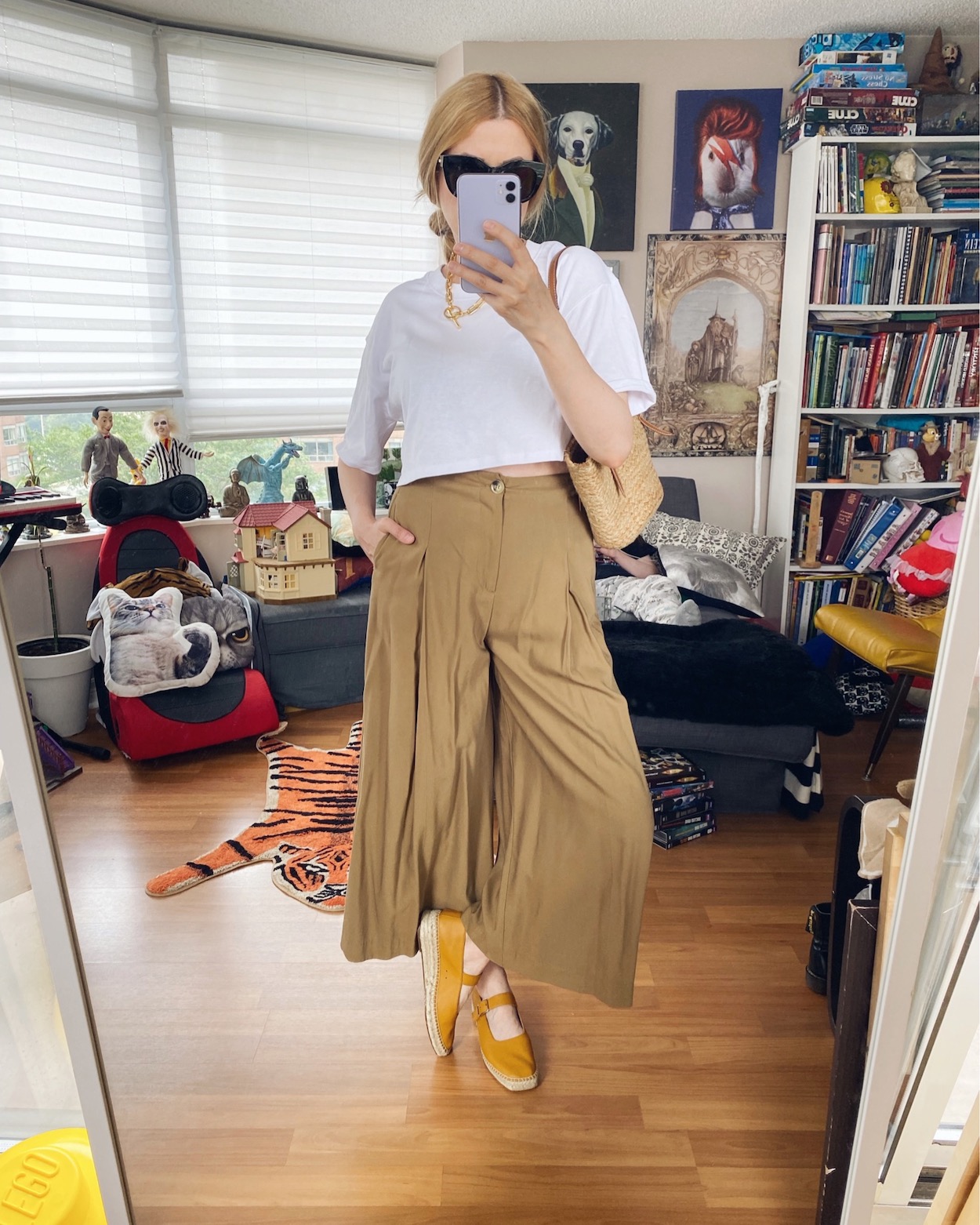 I am wearing a white cropped t-shirt, wide leg trousers, Everlane Mary Jane Espadrilles, a Jenny Bird Necklace, Le Spec sunglasses, and a mini basket bag.