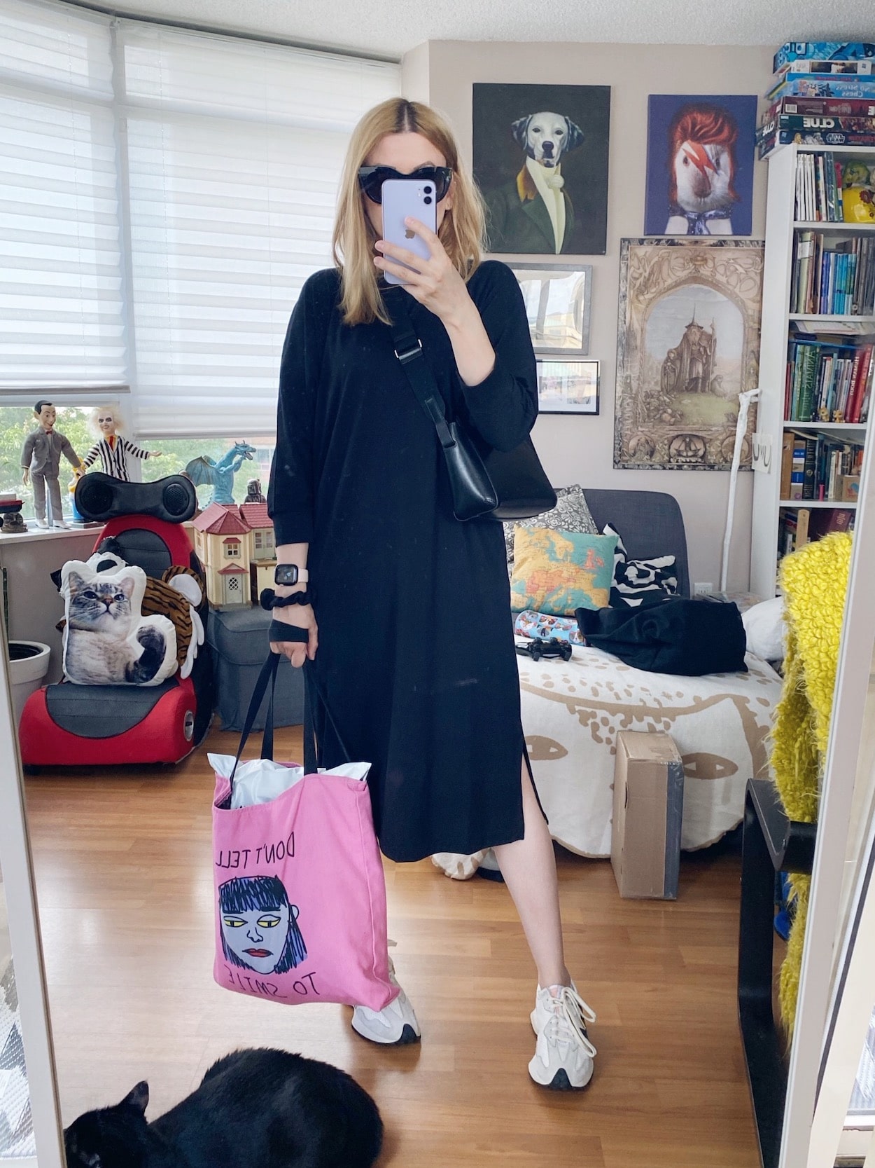 I am wearing a black shirt dress, Everlance crossbody, Le Specs sunglasses, New Balance Sneakers, and a tote.
