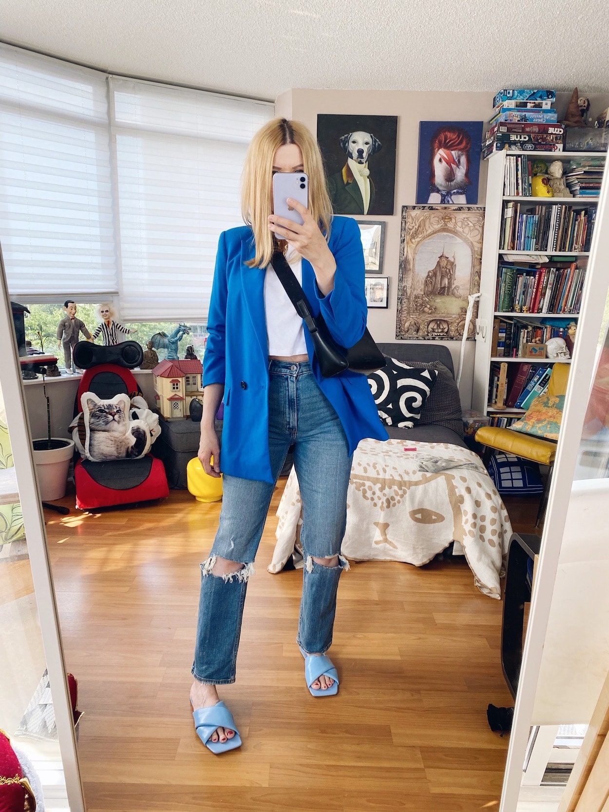 I amwearing a cropped tee, blue blazer, and Abercrombie jeans, with a crossbody, and blue slides.