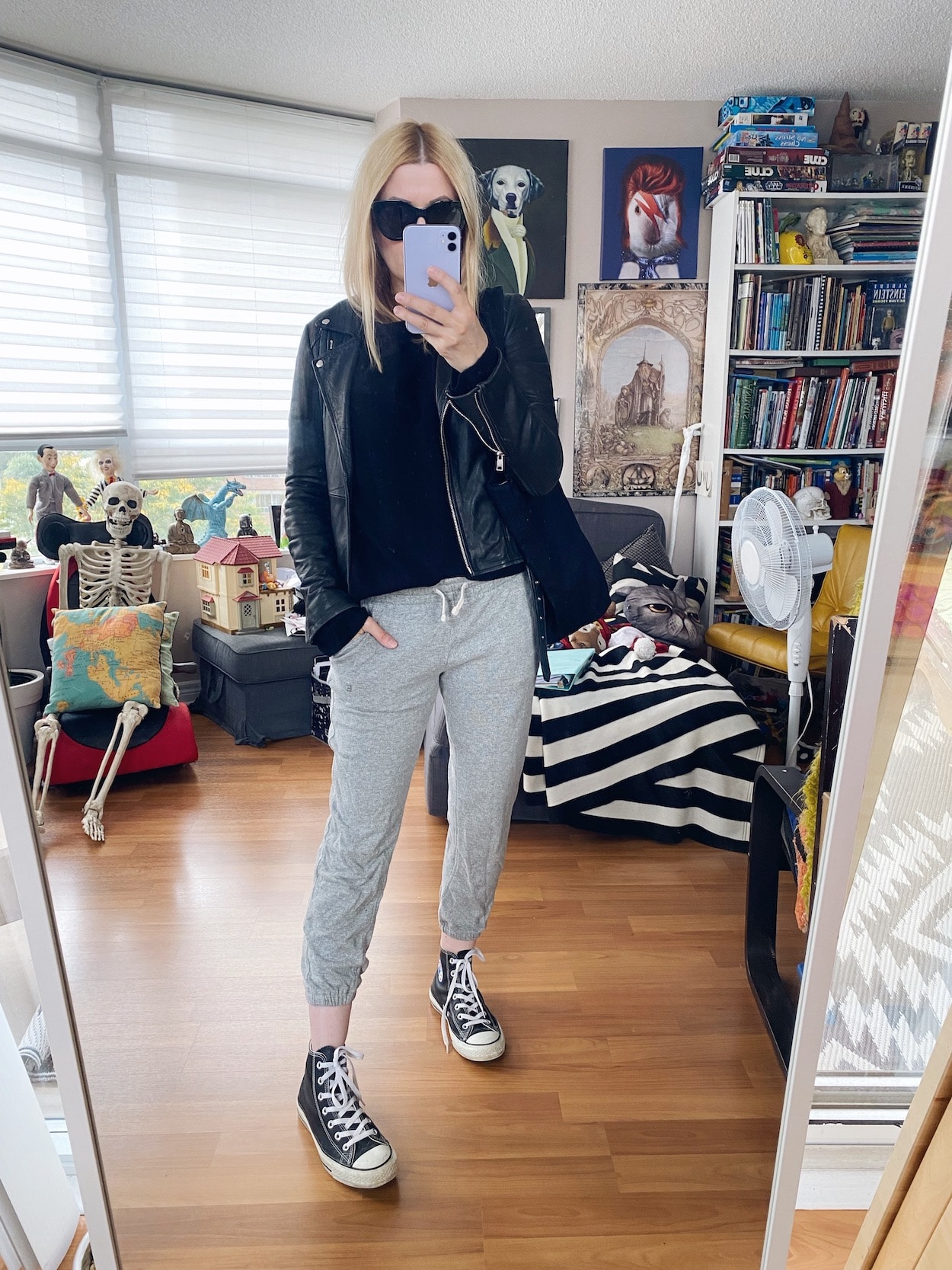 I am weariing joggers, a cashmere sweater, leather moto, Converse, Le Spec sunnies, and a black tote bag.