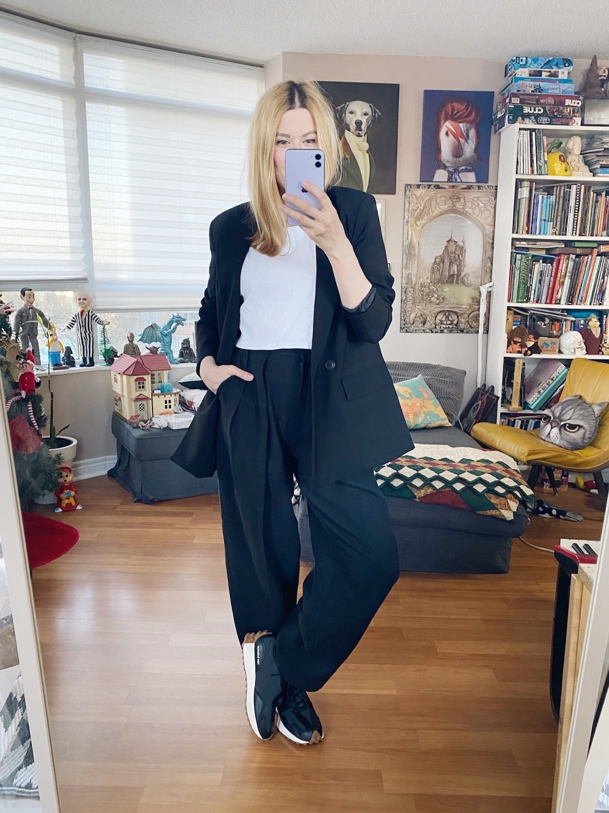 I am wearing trousers, a crop top, and oversized black blazer, and New Balance sneakers.