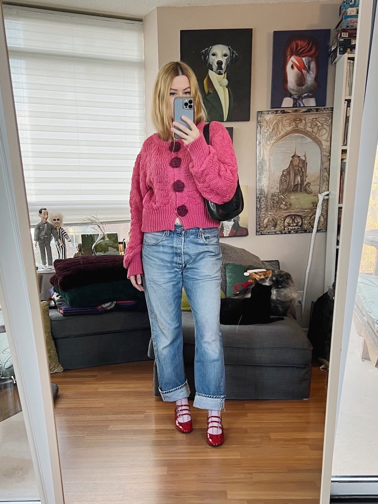 A blonde woman is wearing a cardigan, vintage Levis, Carel Kinas, and a vintage Gucci bag.