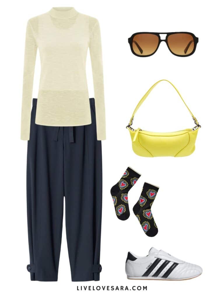 A photo of an outfit of a semi sheer yellow shirt, navy blue trousers, printed socks, a yellow bag, sunglasses, and sneakers.