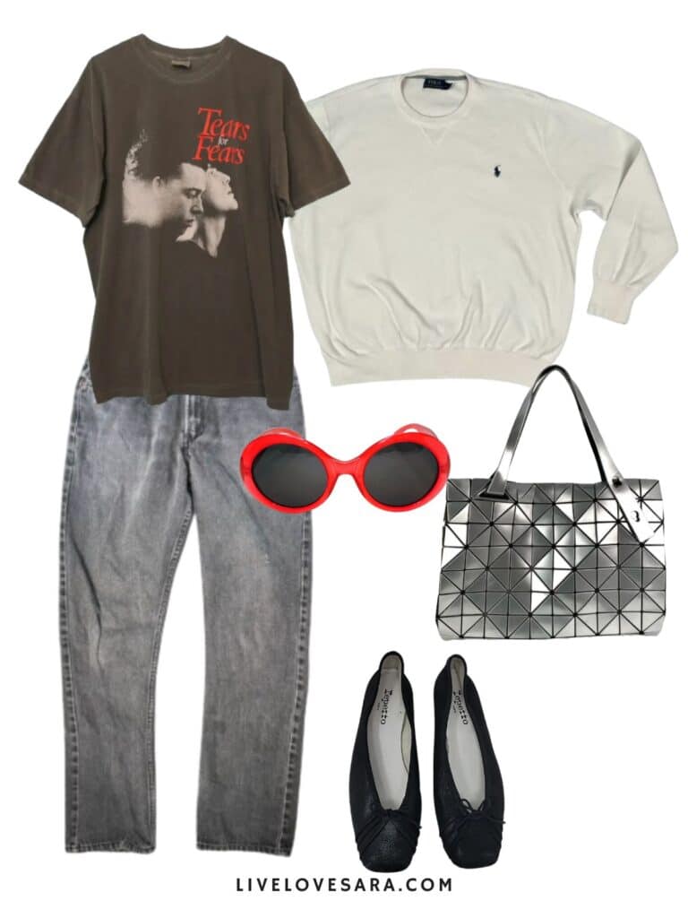 A phot of an outfit of a Tears for Fears tee, Ralph Lauren sweater, grey jeans, an silver Issey Miyake bag, black flats, and red sunglasses.