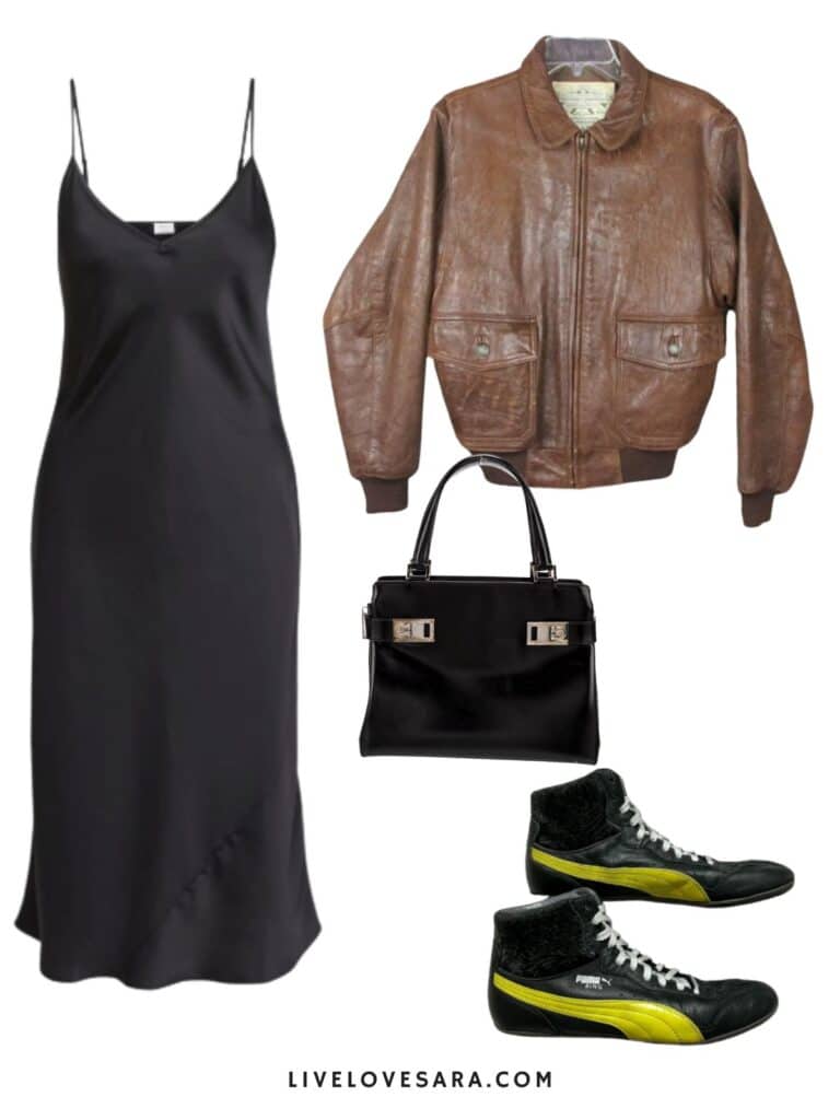 A photo of an outfit of a black slip dress, vintage bomber jacket, a black bag, and vintage Puma high tops.