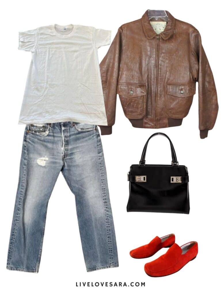 A photo of an outfit of a white vintage tee with vintage Levis, a vintage bomber jacket, red loafers, and a black handbag.