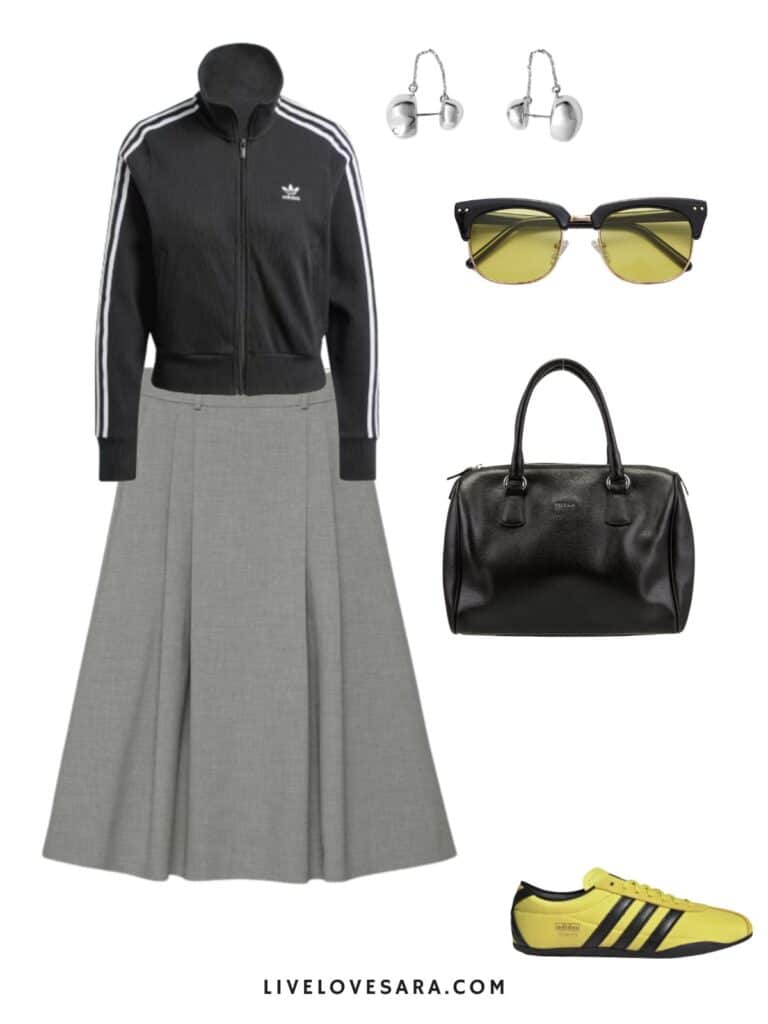 A photo of an outfit of an Adidas track jacket, paired with a grey midi skirt, yellow Adidas Tokyi sneakers, a black bag, sunglasses, and silver earrings.
