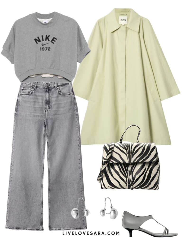A photo of an outfit of a grey cropped Nike sweatshirt, grey jeans, a pale yellow/green jacket, a zebra print bag, silver earrings, and grey kitten heels.
