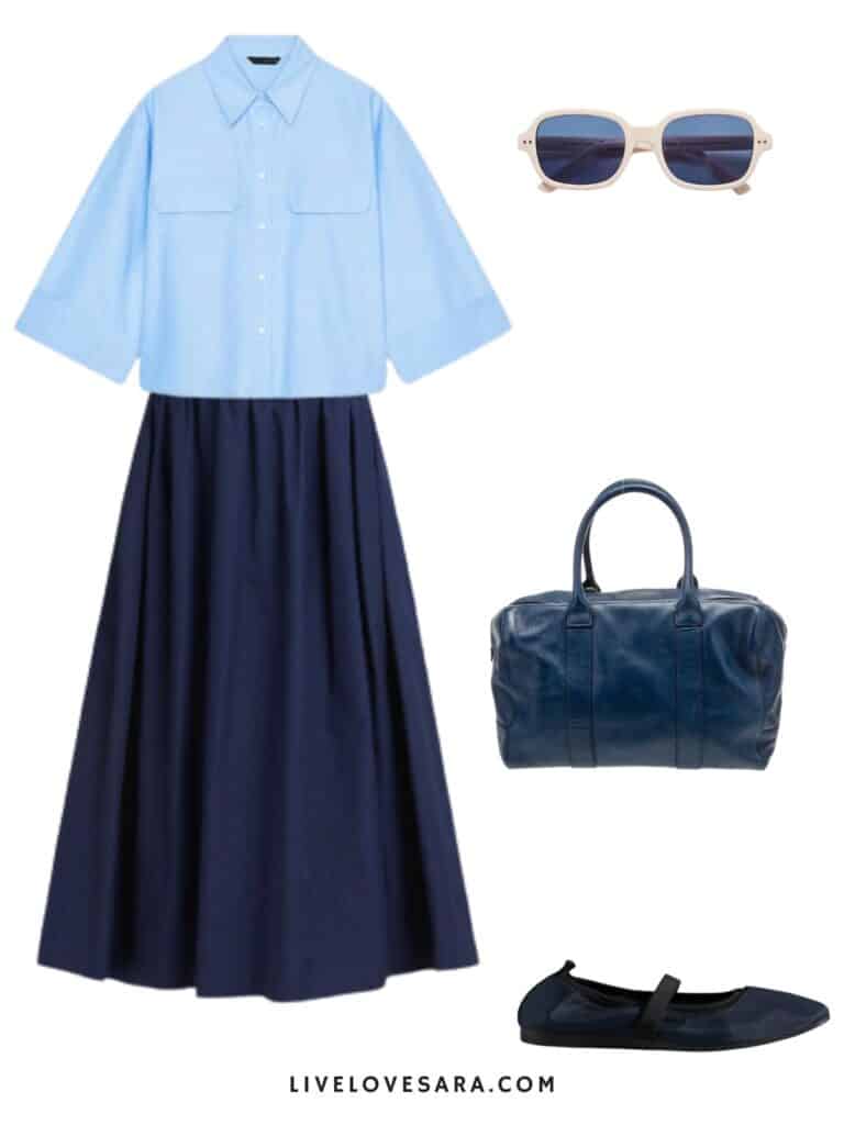 a photo of an outfit of a light blue cropped button down, a navy poplin midi skirt, white sunglasses, navy blue ballet flats, and a navy blue bag.
