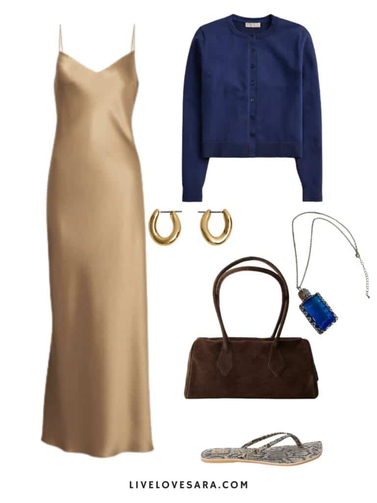 A photo of an outfit of a gold slip dress, navy blue cardigan gold hoop earrings, a perfume bottle necklace, flip flops, and a brown handbag.
