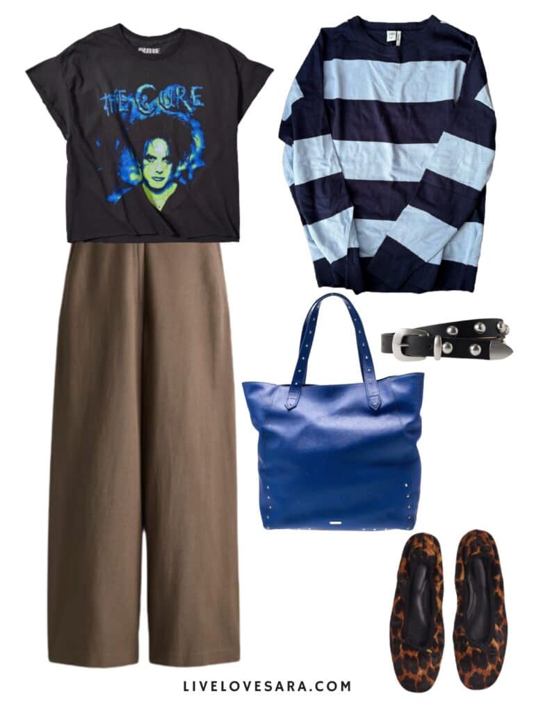A photo of an outfit of a The Cure Tee with brown linen pants, a striped sweater, studded belt, animal print shoes, and a blue tote.