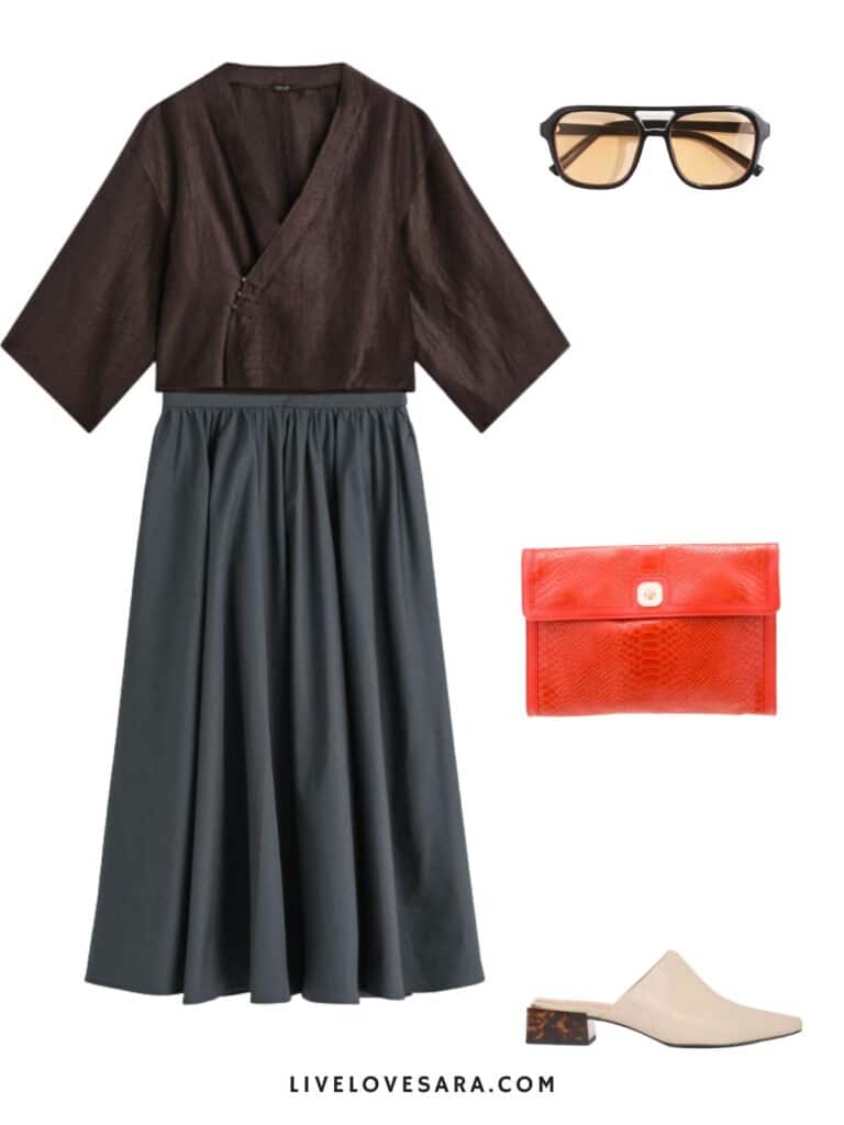A photo of an outfit of a linen kimono top, grey midi skirt, mules, sunglasses, and an orange clutch.