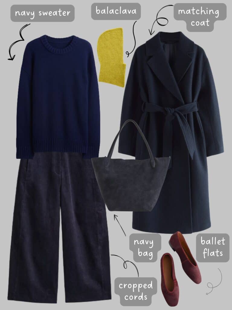 A photo of an outfit of an navy blue sweater with navy cords, a navy wrap jacket, and navy blue suede bag, burgundy flats, and a chartreuse balaclava.