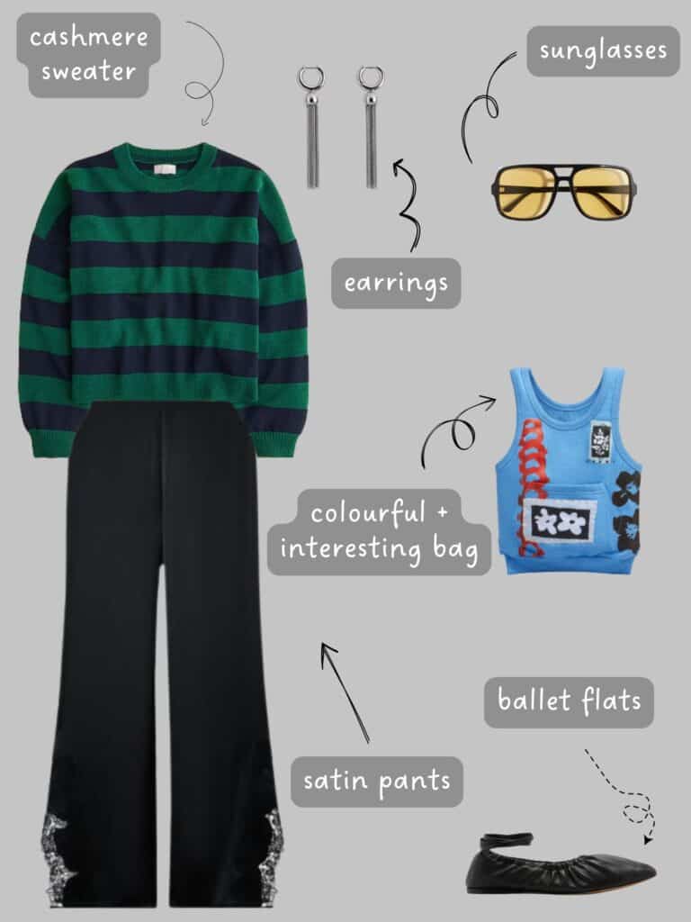 A photo of an outfit of a green and navy blue striped cashmere sweater, black satin pants, silver dangling earrings, yellow lens sunglasses, black ballet flats, and a blue statement bag.