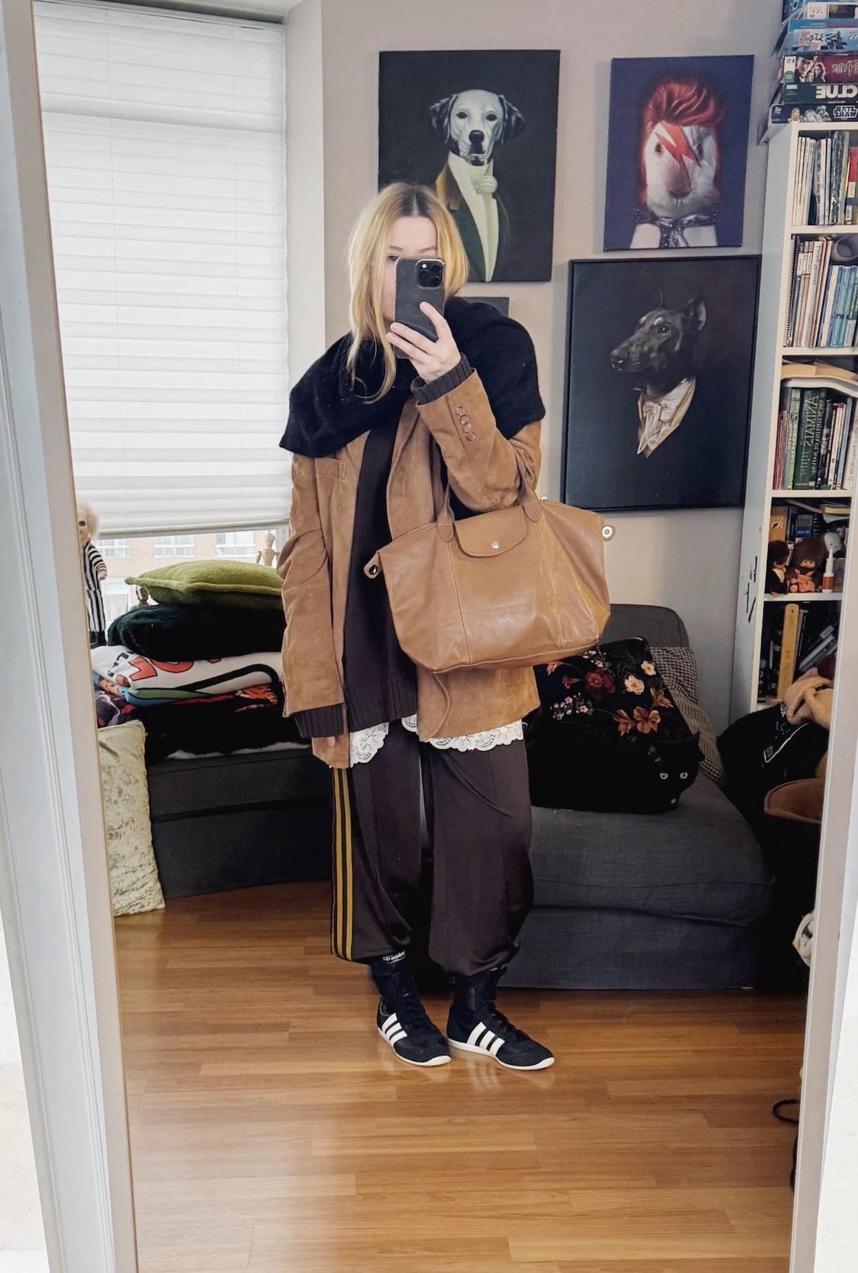 Sara of livelovesara is standing in front of a mirror taking a photo of her outfit. She is wearing a brown sweater over a pink vintage slip, brown Adidas track pants, adidas wrestling sneakers, a brown suede blazer, cashmere scarf, and is carrying a brown leather longchamp bag.