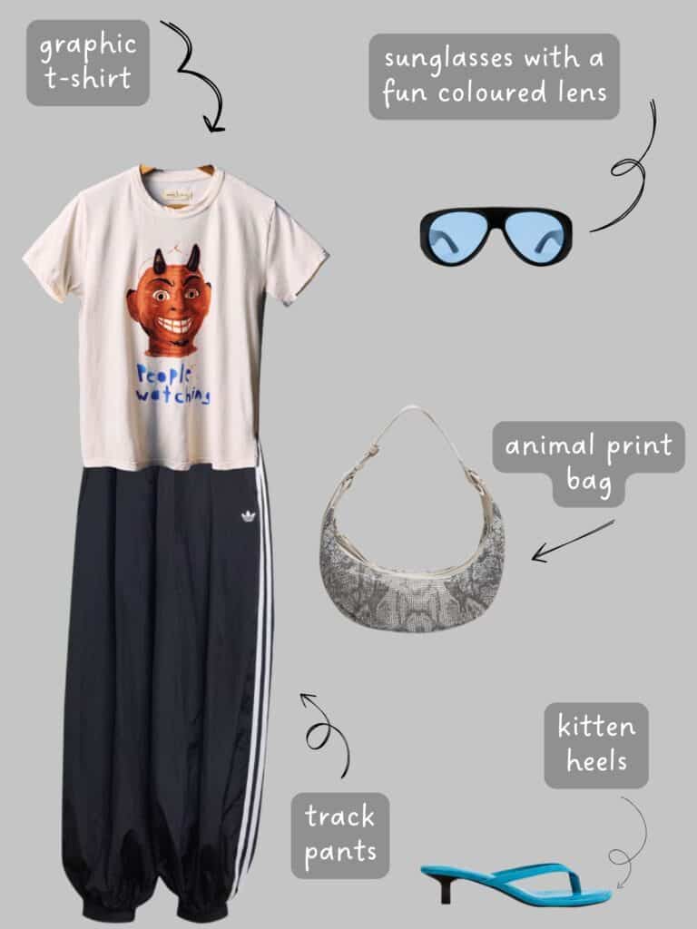 A photo of an outfit of a graphic tee with a drawing of a devil face and "people watching" written on it. Adidas balloon joggers, sunglasses with blue lenses, a snake print bag, and blue kitten heels.
