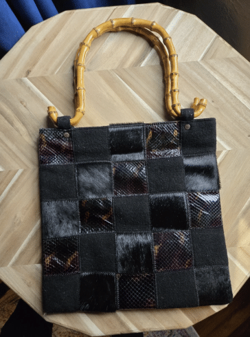 black snake print and calf hair checkered bag with bamboo handle.