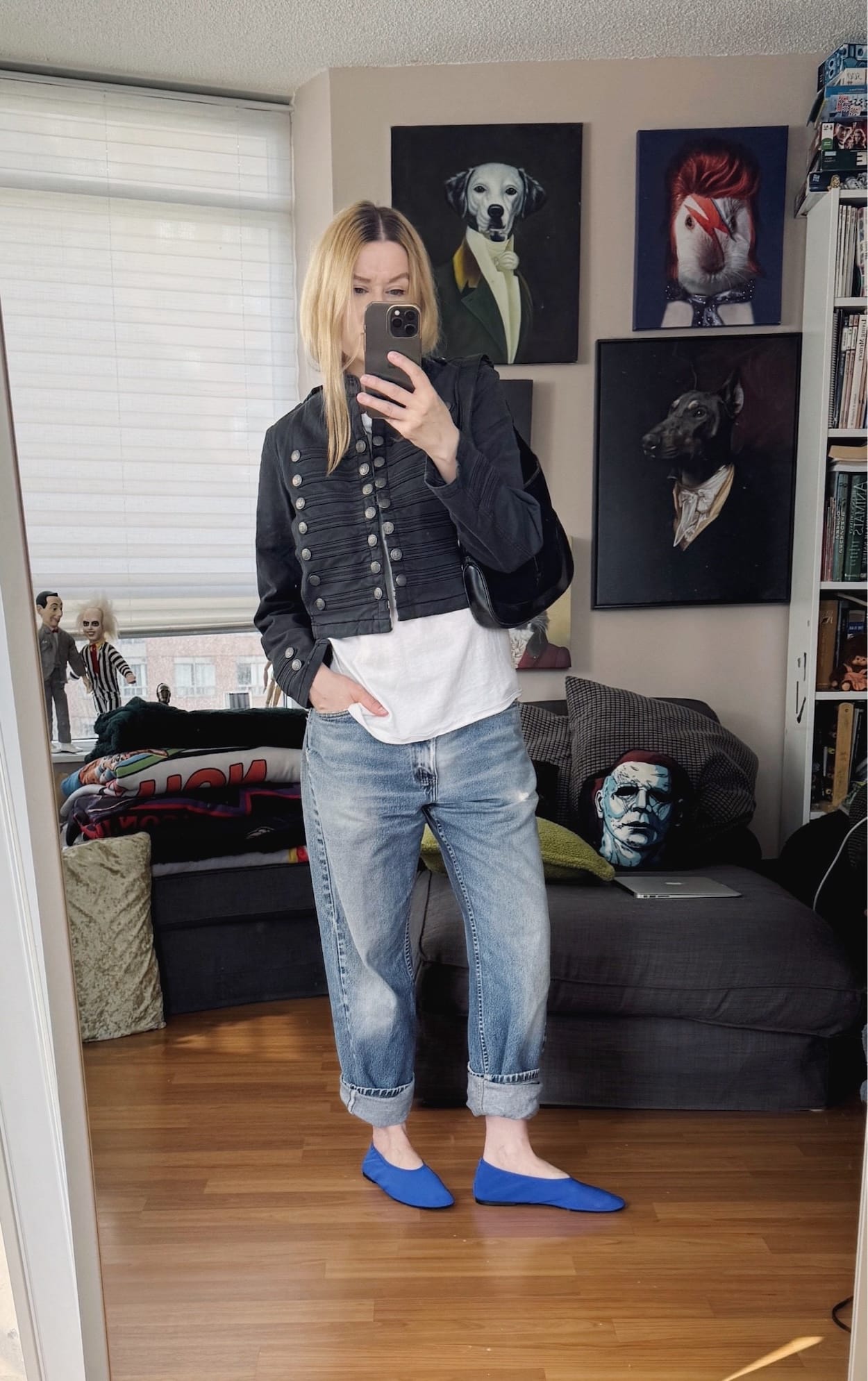 Sara of livelovesara is standing in front of a mirror taking a photo of her outfit. She is wearing a hanes tee with a cropped Napoloen jacket, vintage levis cuffed, blue ballet flats, and a vintage Gucci Jackie bag.