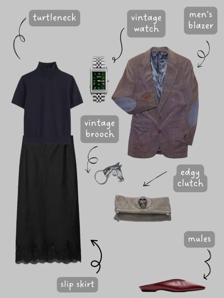 A photo of an outfit of a black turtleneck with a black slip skirt, a men's grey blazer, a vintage horse head brooch, a clutch with a skull and burgundy mules.