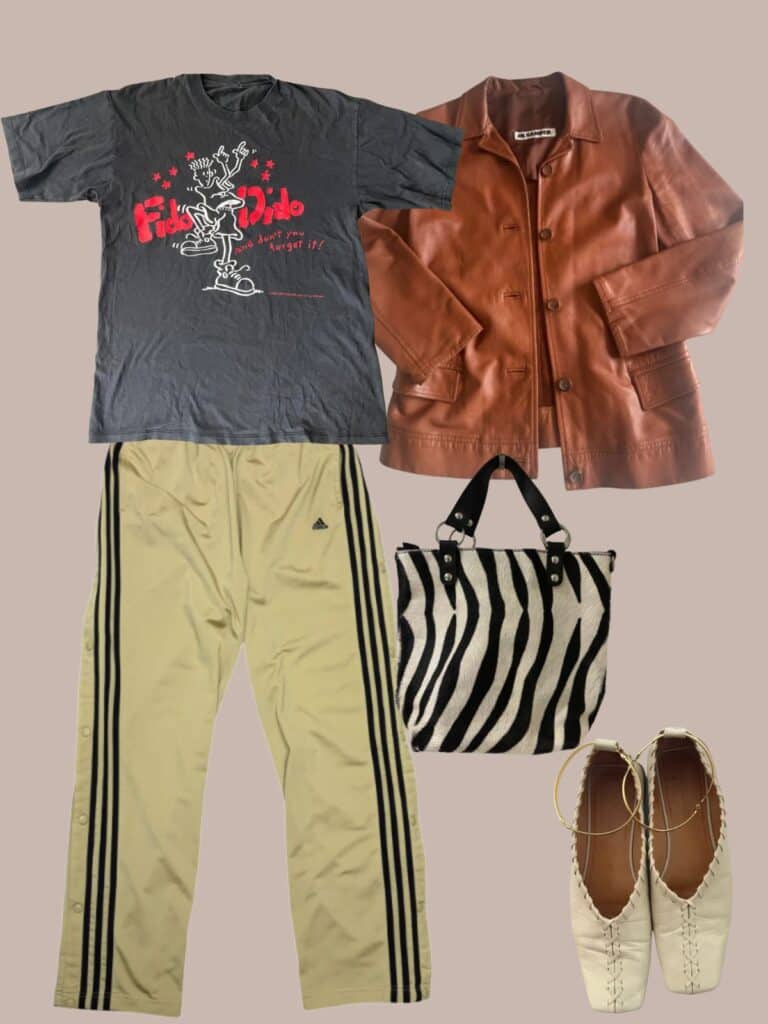 An image of an outfit of a fido dido tee paired with khaki tearaway adidas track pants, a cognac jil sander leather jacket, zebra print bag, and cream Jil Sander flats.